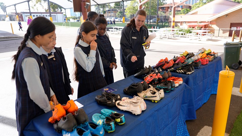 Students at St Margaret Mary’s Primary School peruse a selection of pre-loved boots